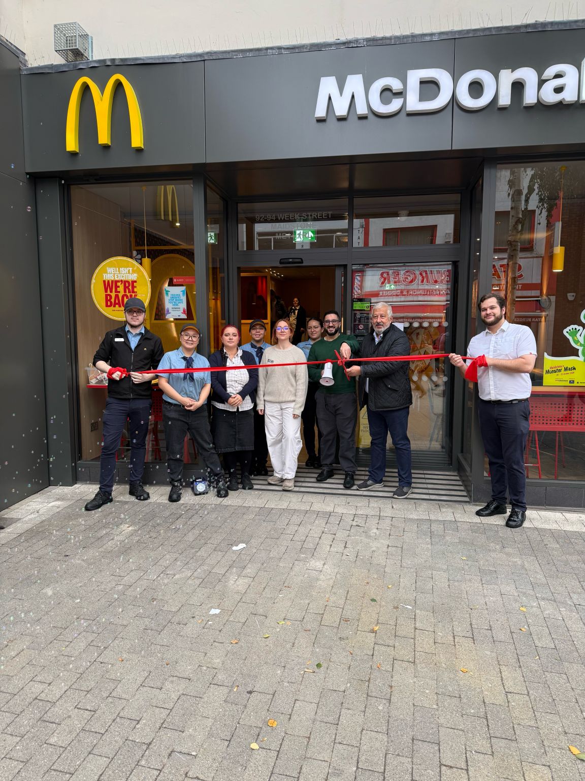 The AMH team cutting the ribbon at the refurbished Week Street McDonald’s.